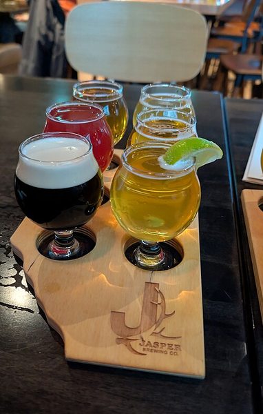 A flight of colorful craft beers in tasting glasses