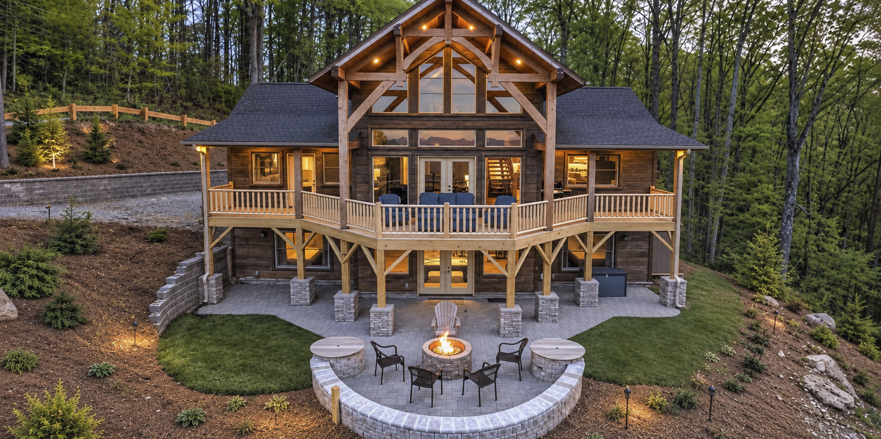 Elk Mountain Escape with the upper glass doors, covered deck, patio seating, and glowing fire pit