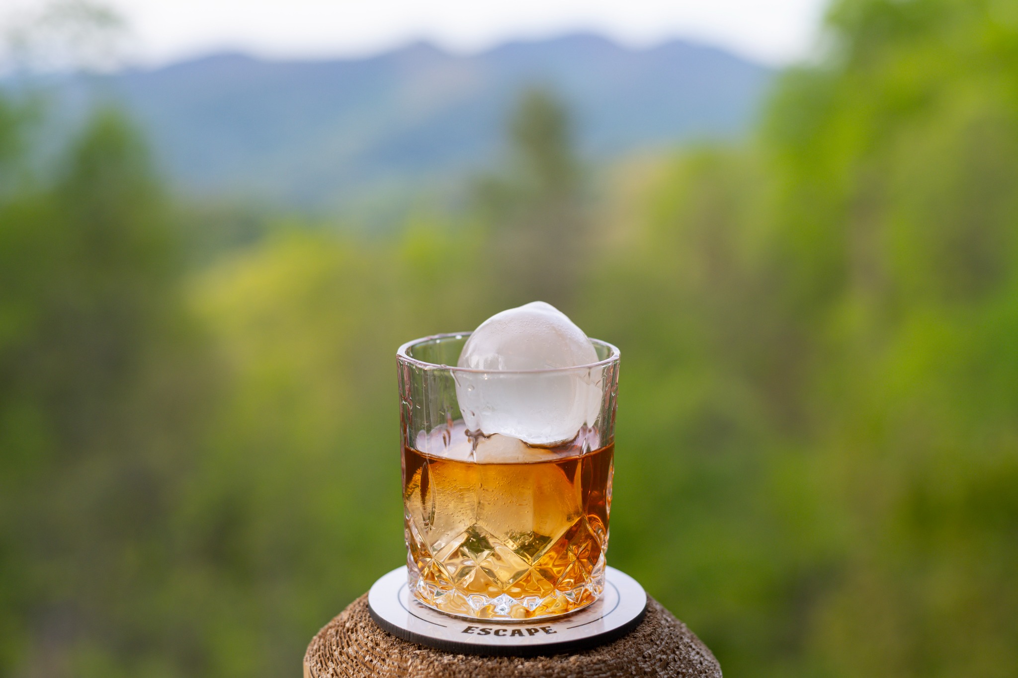 Craft ice with a mountain view · The refrigerator makes round craft ice for your favorite drink, ready to enjoy with a mountain view.