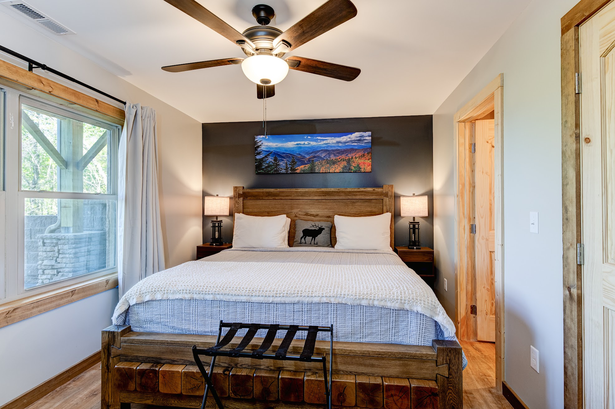 Bedroom 2 · Downstairs king suite · Wood furnishings and mountain artwork