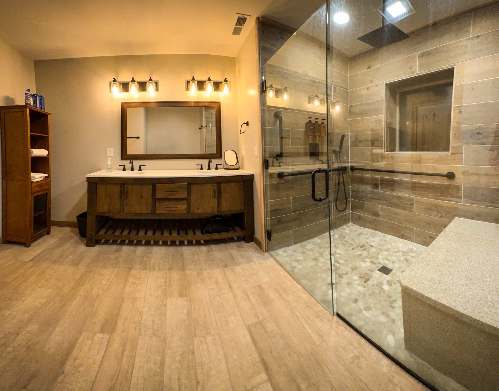 Main-floor suite bathroom · Glass shower with bench