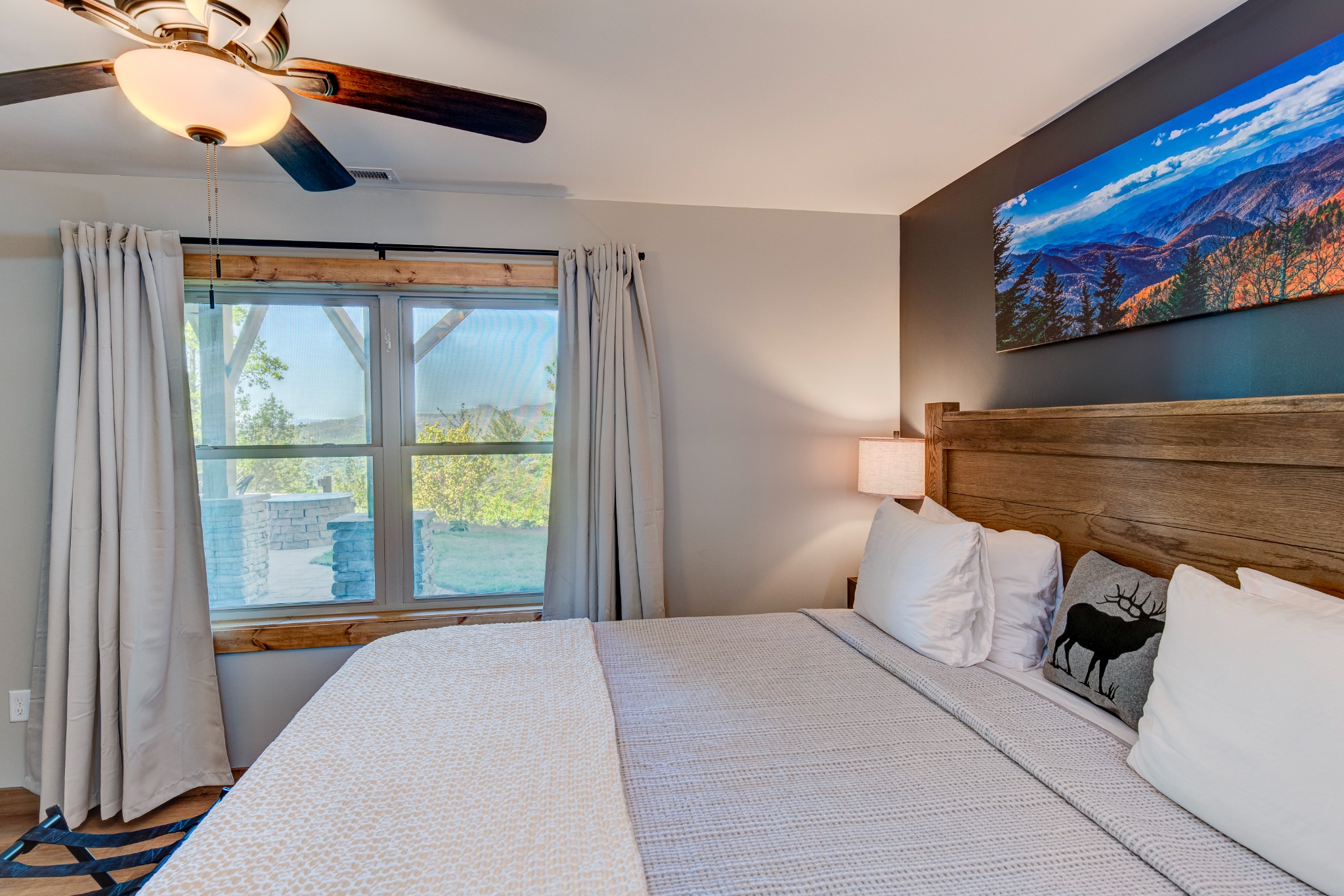 Bedroom 2 · Downstairs king suite · Window and wood headboard